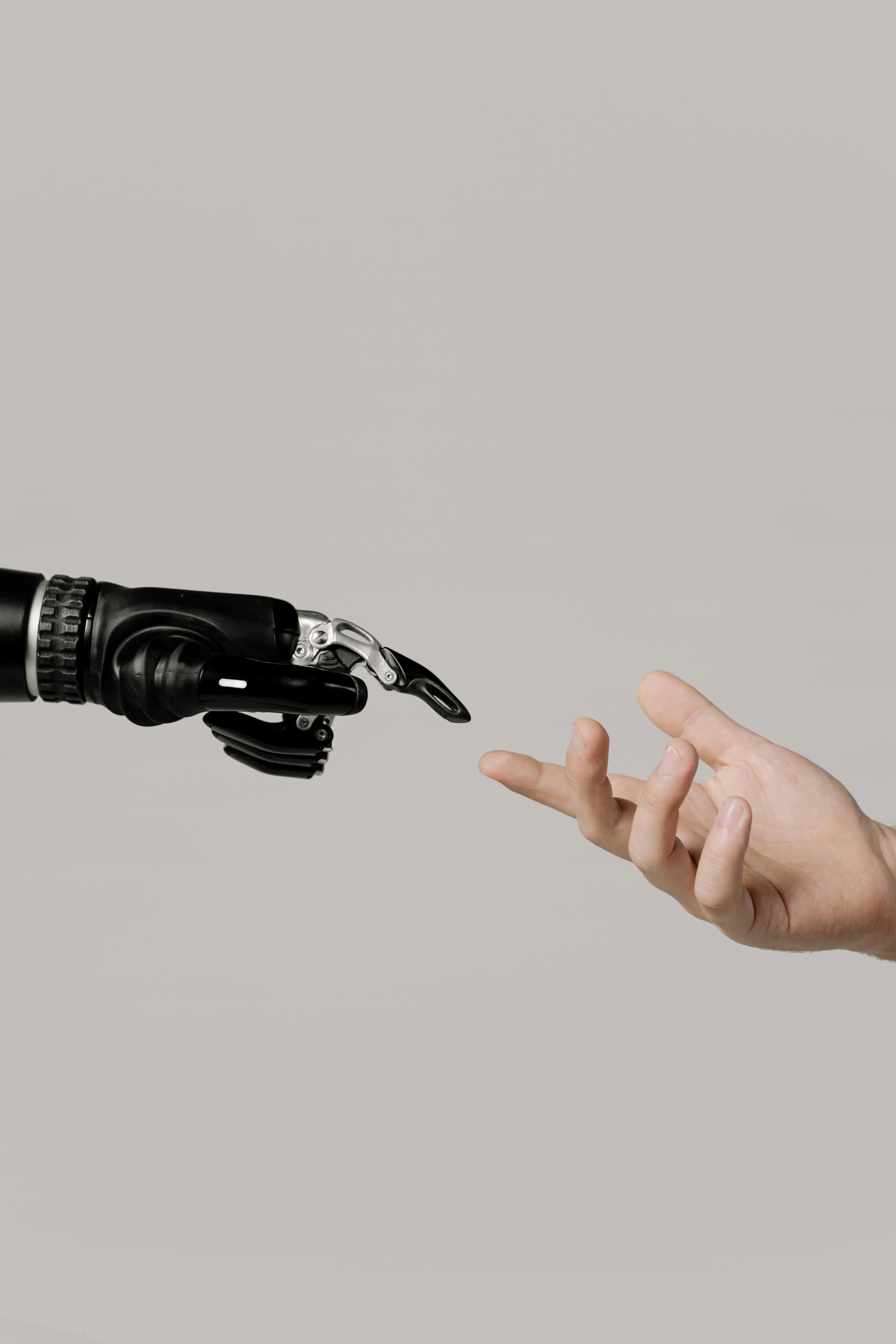 A robotic hand reaching toward a human hand